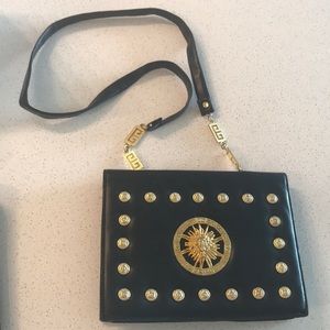 Black shoulder bag with gold sun hardware